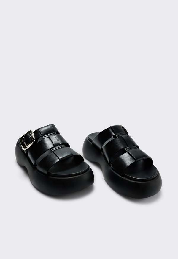 "INTENTIONALLY __________." Nell Platform Sandal