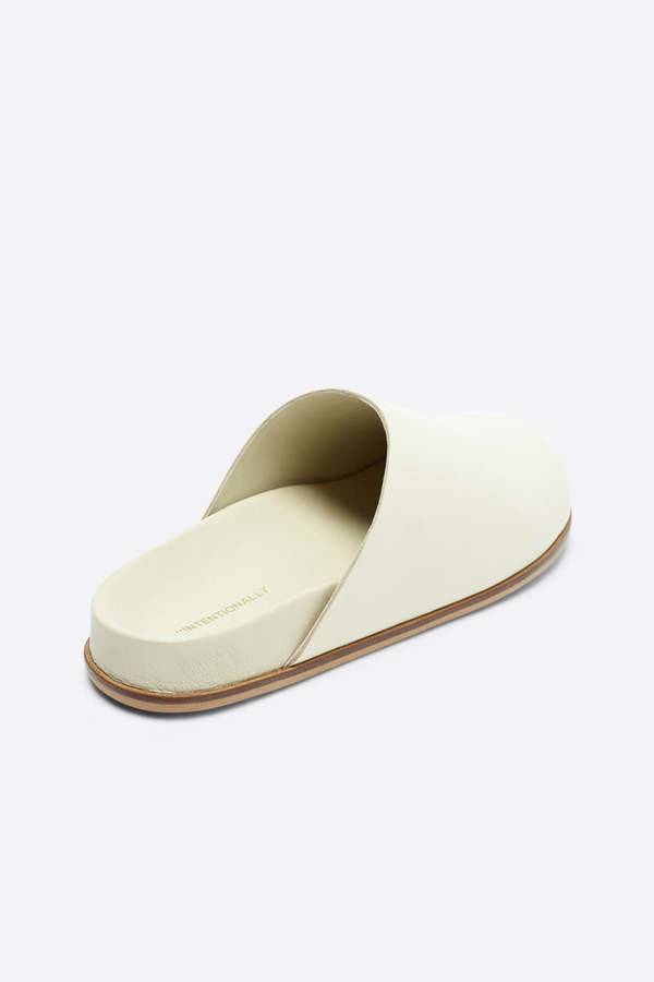 "INTENTIONALLY __________." AGATHA SLIP ON NATURAL SOLE MULE