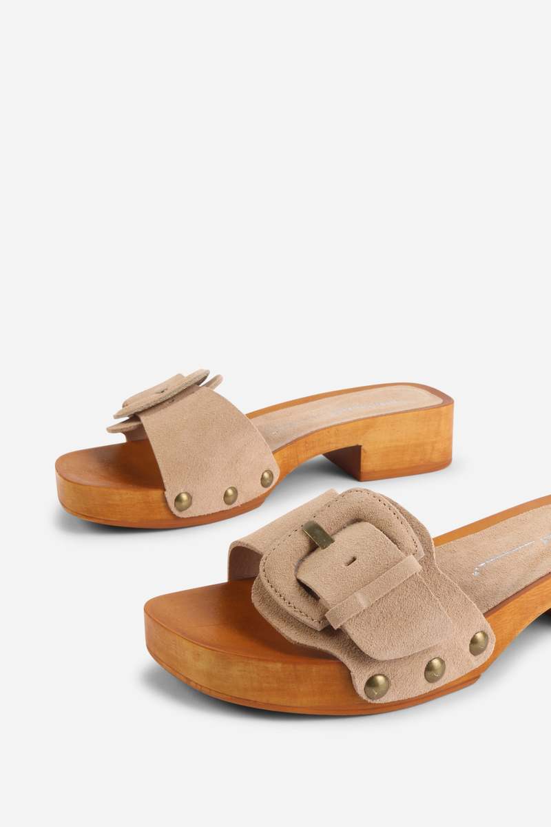 INTENTIONALLY __________. Mar Suede Clog
