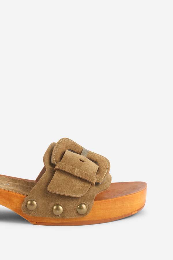 INTENTIONALLY __________. Mar Suede Clog