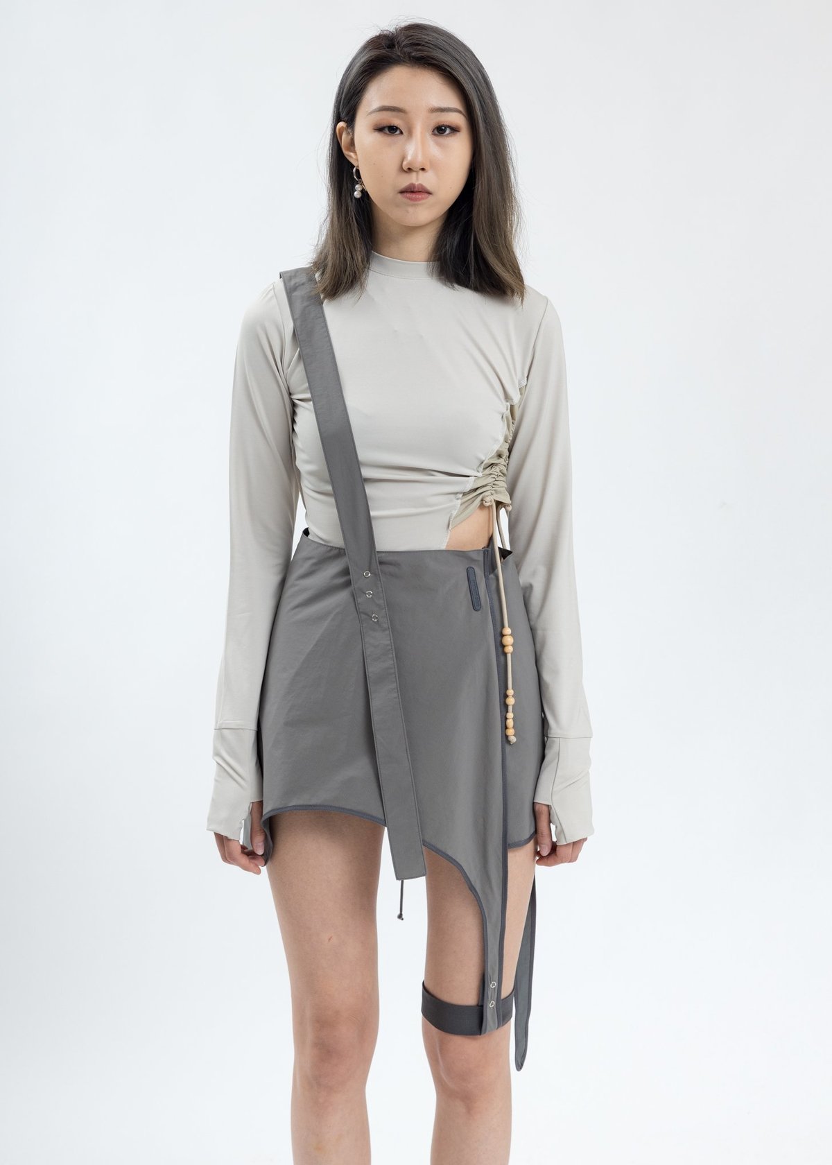 hyein seo pleated skirt with garter belt The HYEIN SEO SS19 Collection is filled with monochromatic garbs in the  form of long-sleeve crop tops, pleated skirts with hanging garter straps,  baggy cargo pants, grommet belts and semi-translucent long coats main image 1