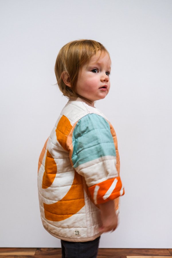 Kids CanDid Art Shapes & Angles Reversible Quilted Coat - Orange Kids CanDid Art Shapes & Angles Reversible Quilted Coat - Orange