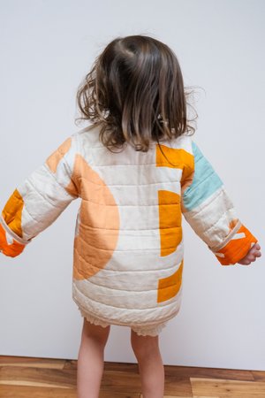 Kids CanDid Art Shapes & Angles Reversible Quilted Coat - Orange Kids CanDid Art Shapes & Angles Reversible Quilted Coat - Orange