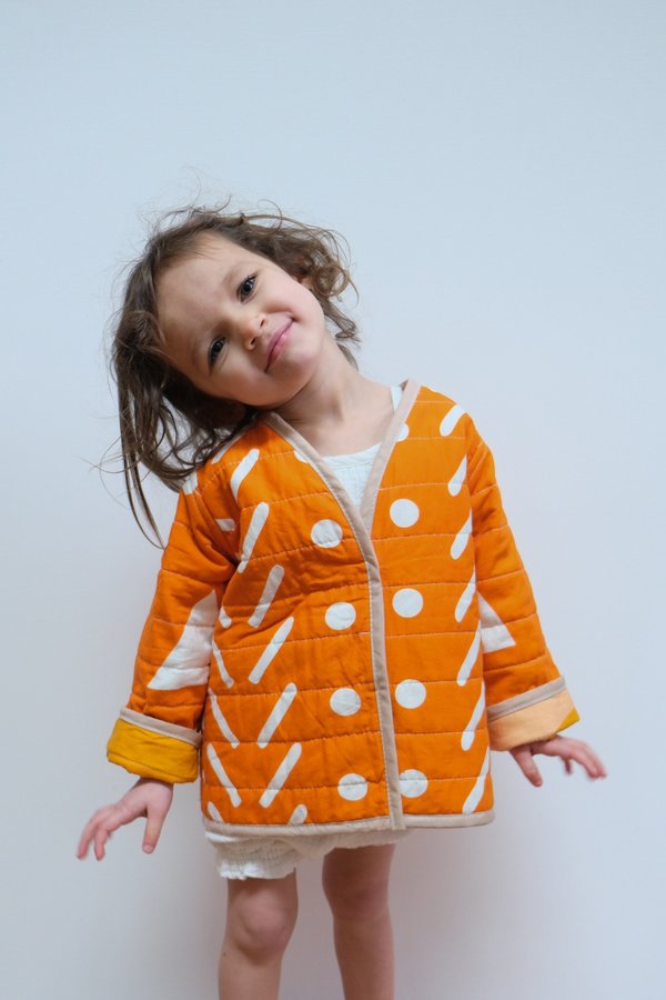 Kids CanDid Art Shapes & Angles Reversible Quilted Coat - Orange Kids CanDid Art Shapes & Angles Reversible Quilted Coat - Orange