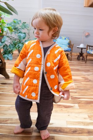 Kids CanDid Art Shapes & Angles Reversible Quilted Coat - Orange Kids CanDid Art Shapes & Angles Reversible Quilted Coat - Orange