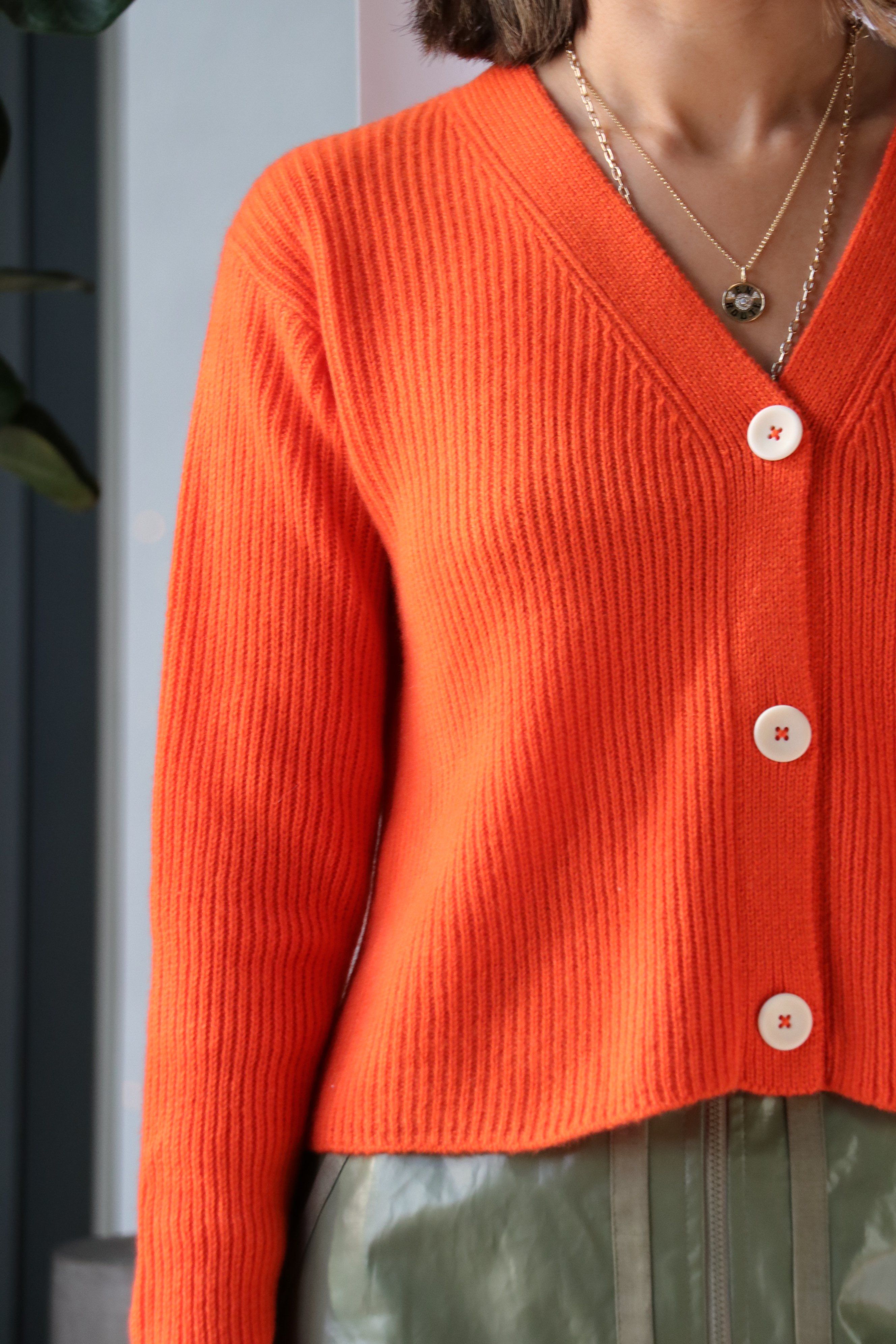 bright orange cardigan