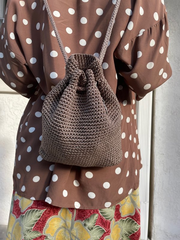 Knitted String Bag Weighs On A Vintage Brick Wall Stock Photo