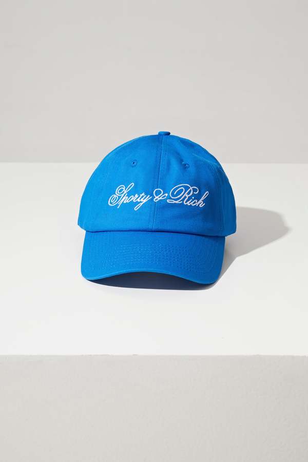 キャップ SPORTY & RICH CURSIVE LOGO HAT BLUE Sporty & Rich Blue Cursive Logo Cap - ShopStyle Hats